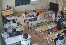 The teacher remove heels relax her tired feet under the desk