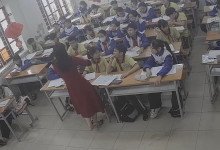 The teacher dangling shoeplay and dipping many times during class 23