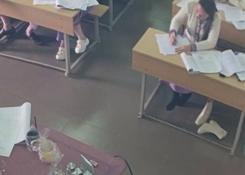 The student remove her white boots relax her black nylon feet