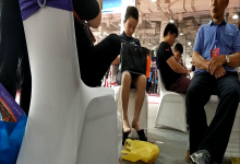 Lady great dangling shoeplay when waiting for the train in railway station lounge