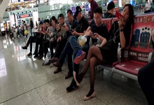 Lady great dangling shoeplay when waiting for the train in railway station lounge 4