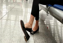 Lady great dangling shoeplay when waiting for the train in railway station lounge 15