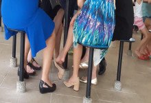 The hot lady bare feet dangling shoeplay under the table