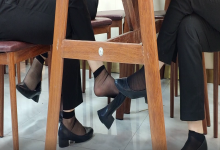 The girl dangling shoeplay under the table when having lunch 22