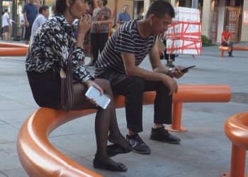 The middle age lady in black nylon  dangling shoeplay on the chair The middle age lady in black nylon  dangling shoeplay on the chair