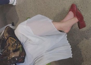 The pretty girl great in red heels bare feet dangling shoeplay