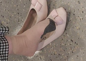 The beautiful woman in  special pattern stockings dangling shoeplay