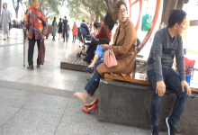 Lady remove her red heels and shaking her nylon feet