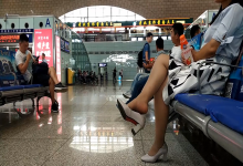 Girl relax her tired nylon feet when waiting for a train 2