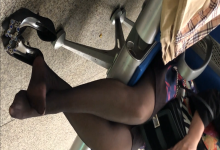 Girl remove heels and relax her sexy black nylon feet on the chair when waiting for a train