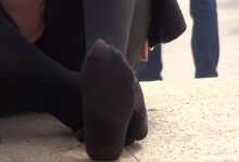 A pair of sexy feet in black thick silk stockings
