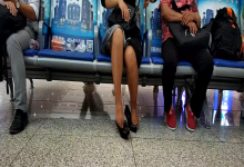 Lady remove shoe and relax her tired feet on the chair when waiting for a train 21