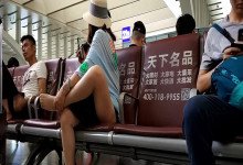 Lady remove shoe and relax her tired feet on the chair when waiting for a train 29