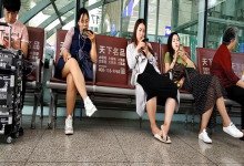 Lady remove shoe and relax her tired feet on the chair when waiting for a train 30