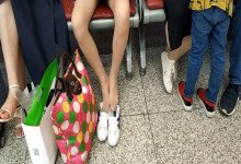 Lady remove shoe and relax her tired feet on the chair when waiting for a train 31