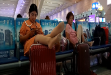 Lady remove shoe and relax her tired feet  when waiting for a train 35