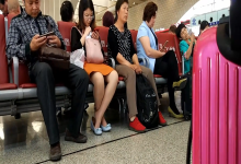 The girl remove shoes relax her tired feet when waitting for a train 13