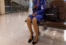 The lady remove heels relax her feet when line up in the airport waiting hall 5