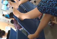 The lady relax her tired feet when line up in the waiting hall 105