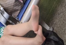 The lady remove shoes relax her tired feet when waitting for a train 48