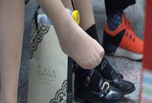 The girl remove shoes relax her tired feet when waitting for a train 