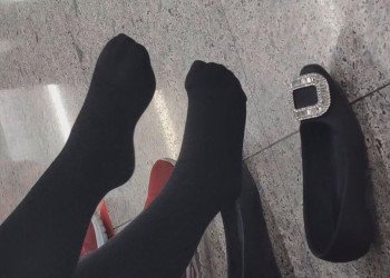 The girl black thick stockings took off her shoes to relax her feet