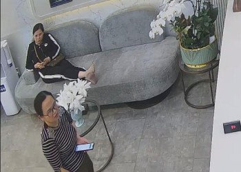 The customer relaxes their feet on the sofa