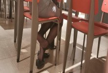 Hot lady sit down dippng shoeplay under the table