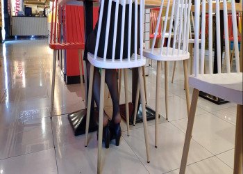 The hot girl in black nylon dipping shoeplay when having lunch