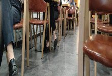 The girl dangling shoeplay under the table when having lunch 12
