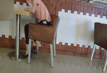 The girl dangling shoeplay under the table when having lunch 29