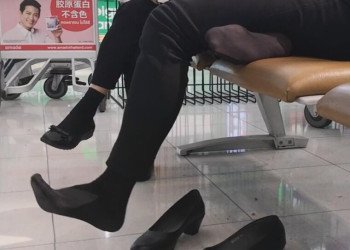 The hostess show us her cute black nylon feet