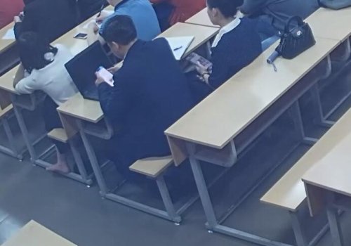 She took off her high heels to show her beautiful feet to her male classmates.