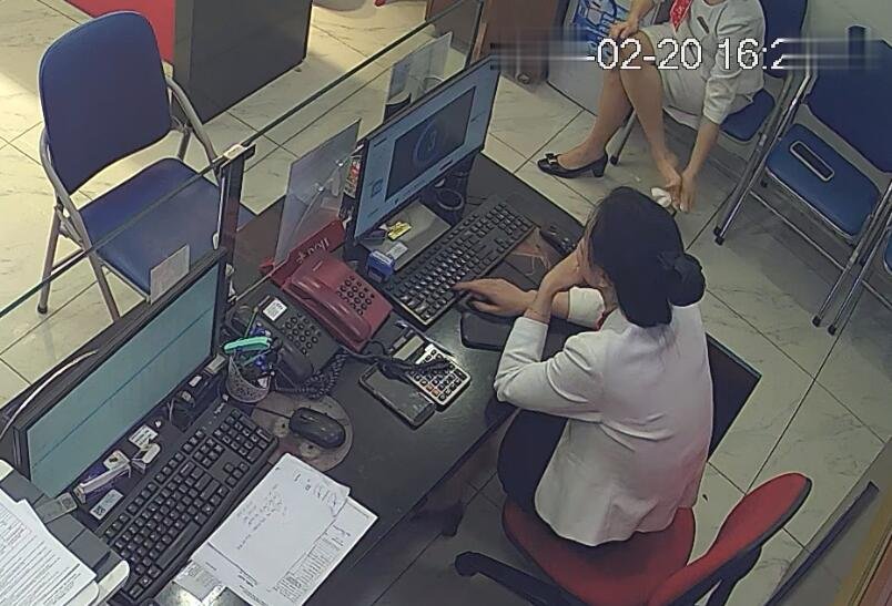 She is wiping her feet and shoes with tissue