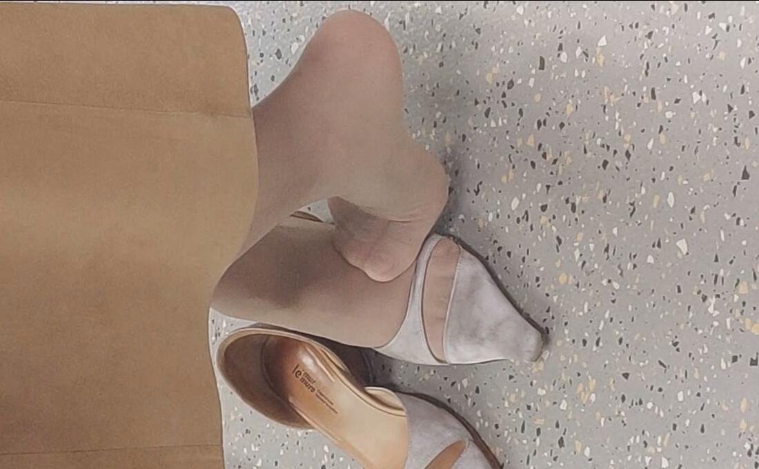 The pretty lady in white nylon dangling and dipping shoeplay