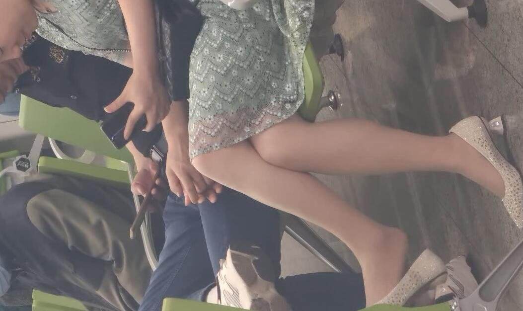 The lady in white heels dangling shoeplay when waiting for a call