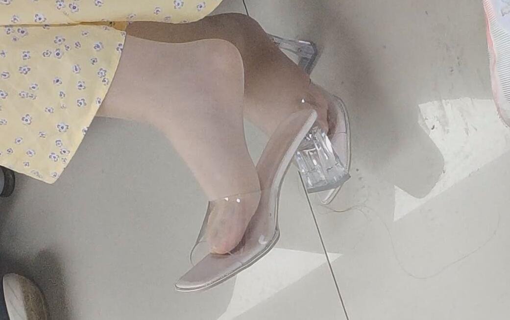 The lady in white heels dangling shoeplay when waiting for a call 8