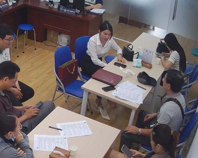 The pretty girl in white heels dangling shoeplay under the table