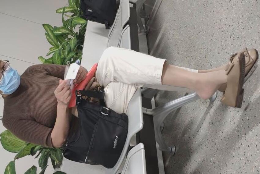 The lady in white heels dangling shoeplay when waiting for a call 13