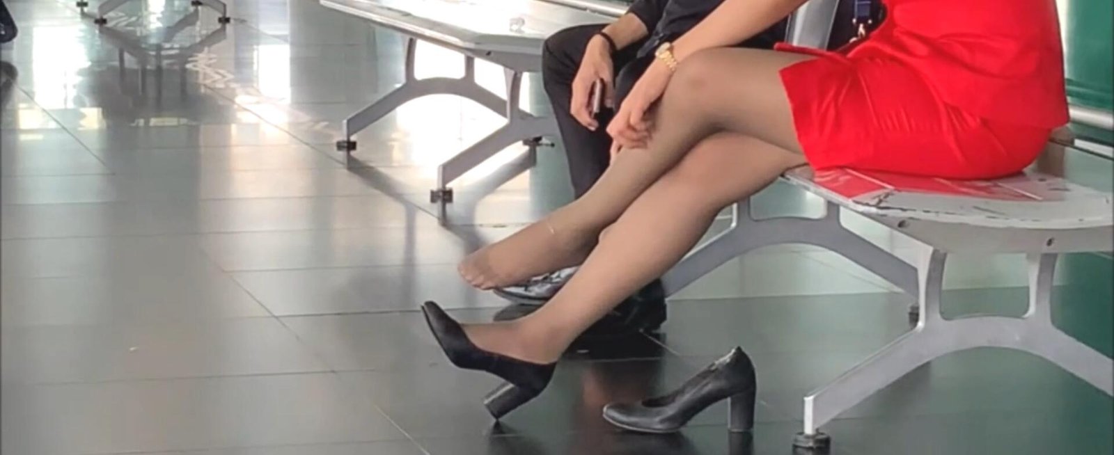 The hot lady in red dress take off heels relax her feet