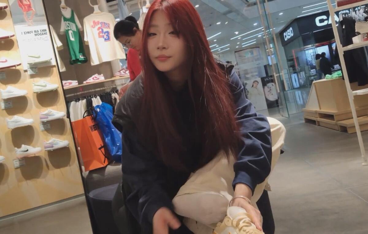 Beautiful girl trying on new shoes in shoe store